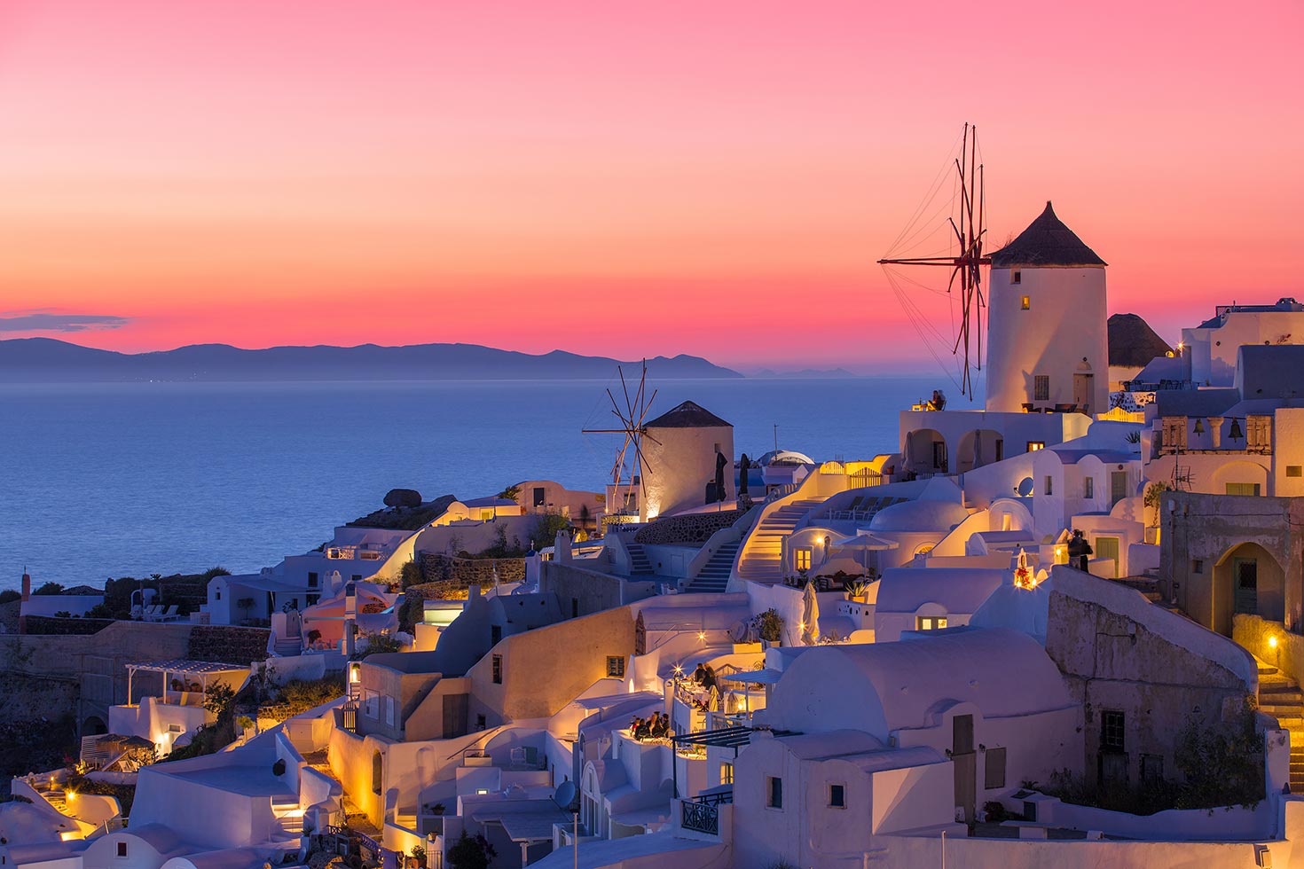 Watching the famous sunset from Oia castle ruins during a 3-day Santorini ATV itinerary.