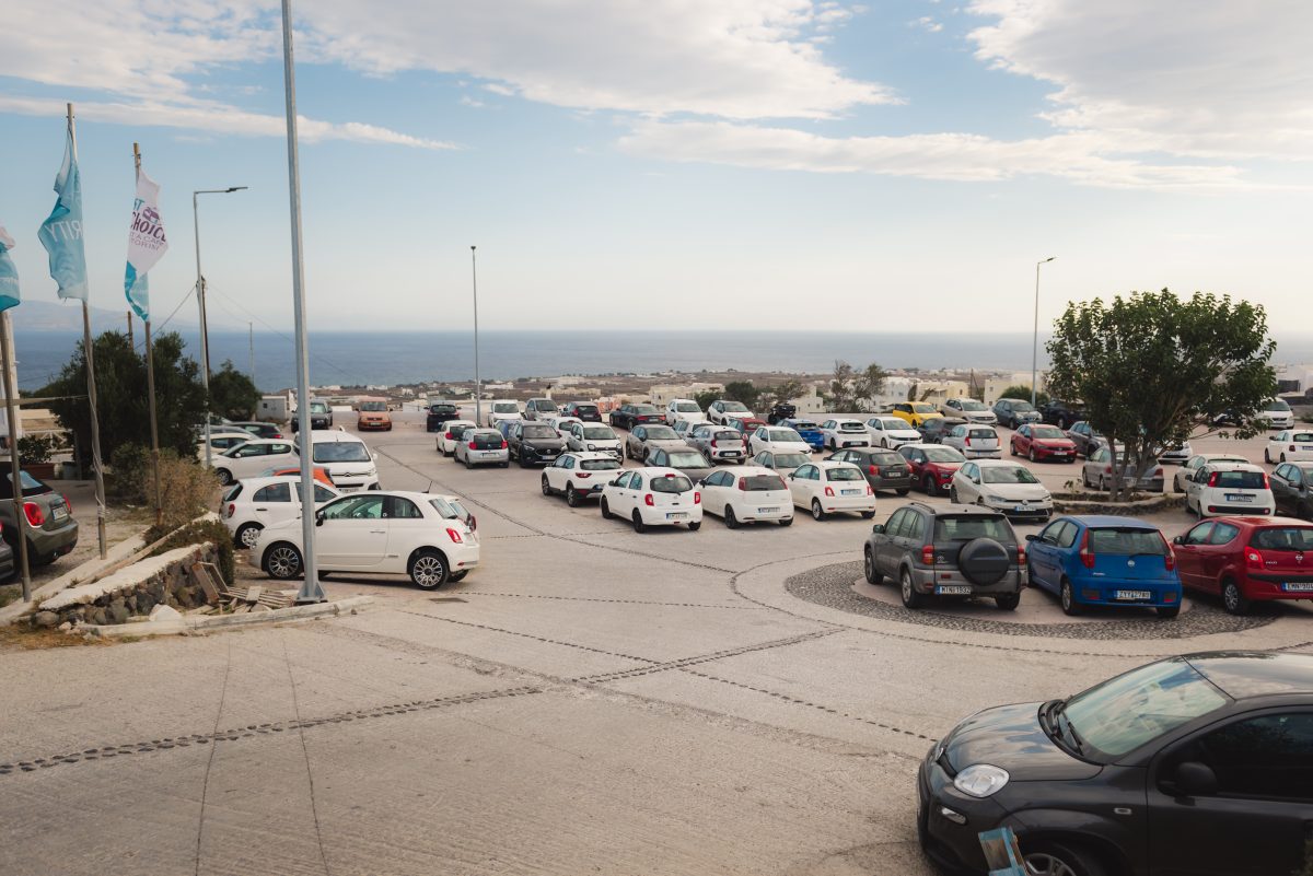 Designated parking zones for a santorini moto rent near the Oia sunset viewing points.